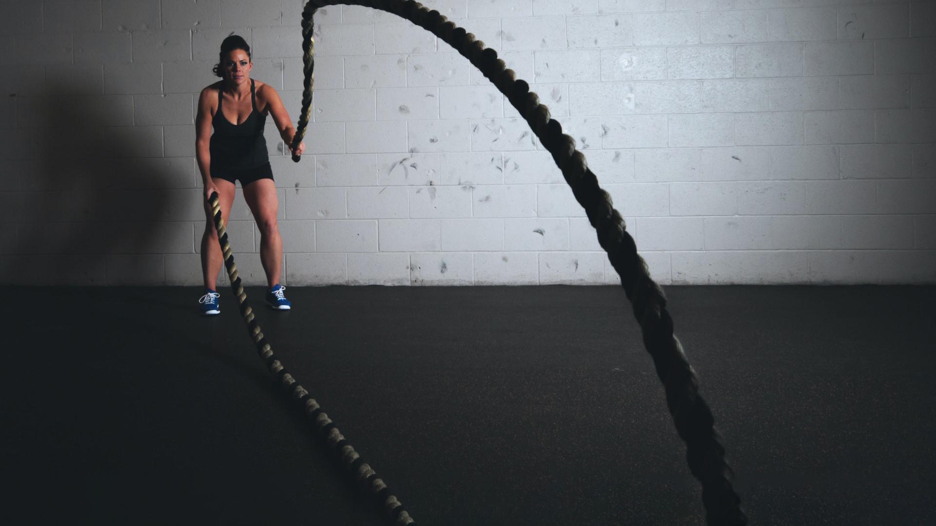 Woman in the gym with a rope